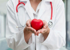 Doctor holding a red heart